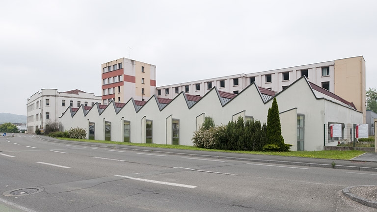 laminoir Peugeot Frères, puis les Fils de Peugeot Frères, puis usine de cycles de la Société Anonyme des Automobiles et Cycles Peugeot (SAACP), puis Société Anonyme des Cycles Peugeot (SACP), puis usine de construction mécanique Equipements et Composants pour l'Industrie l'automobile (ECIA), actuellement Faurecia et Fuji Autotech France